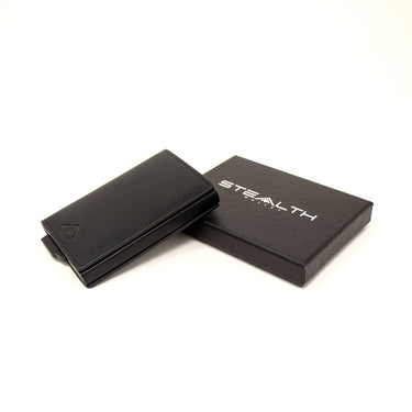 Photo of the Avenger RFID Enhanced Bifold Wallet next to a black stealth wallets gift box on a white background