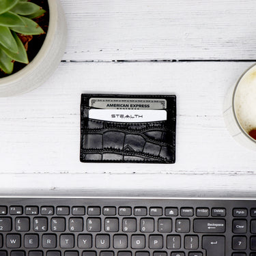 Picture of a Raider RFID Wallet laid on a tablet next to a computer keyword