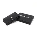 Photo of a black Avenger RFID Bifold Wallet next to a stealth wallet gift box